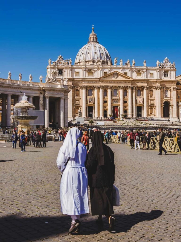 Nuns walking in Italian piazza.