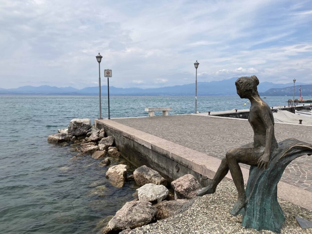 Mermaid statue on Lake Garda shore in Lazise, Italy.