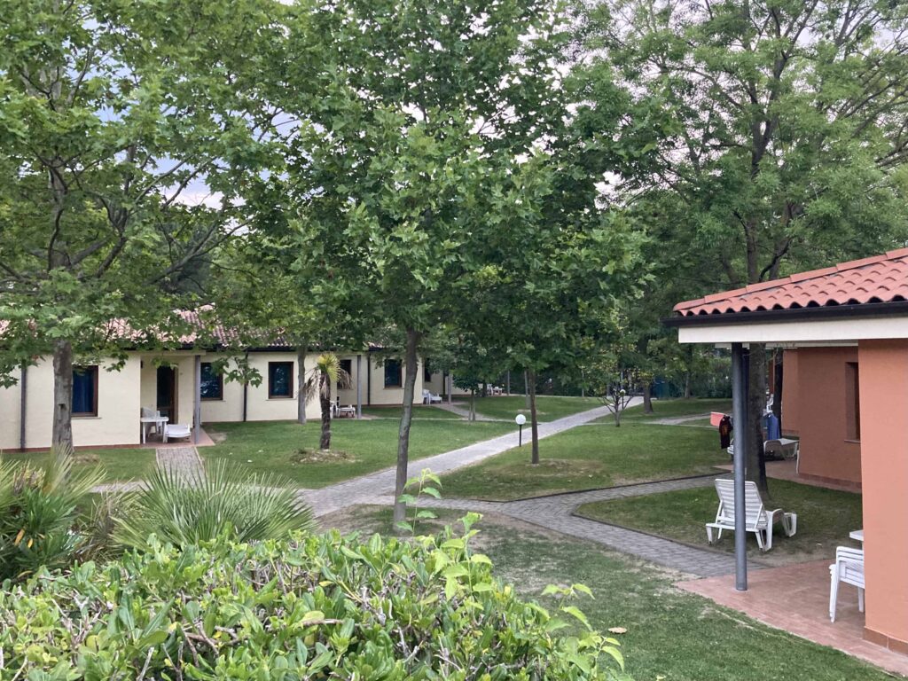 Bungalows and grassy area at Camping Bella Italia.