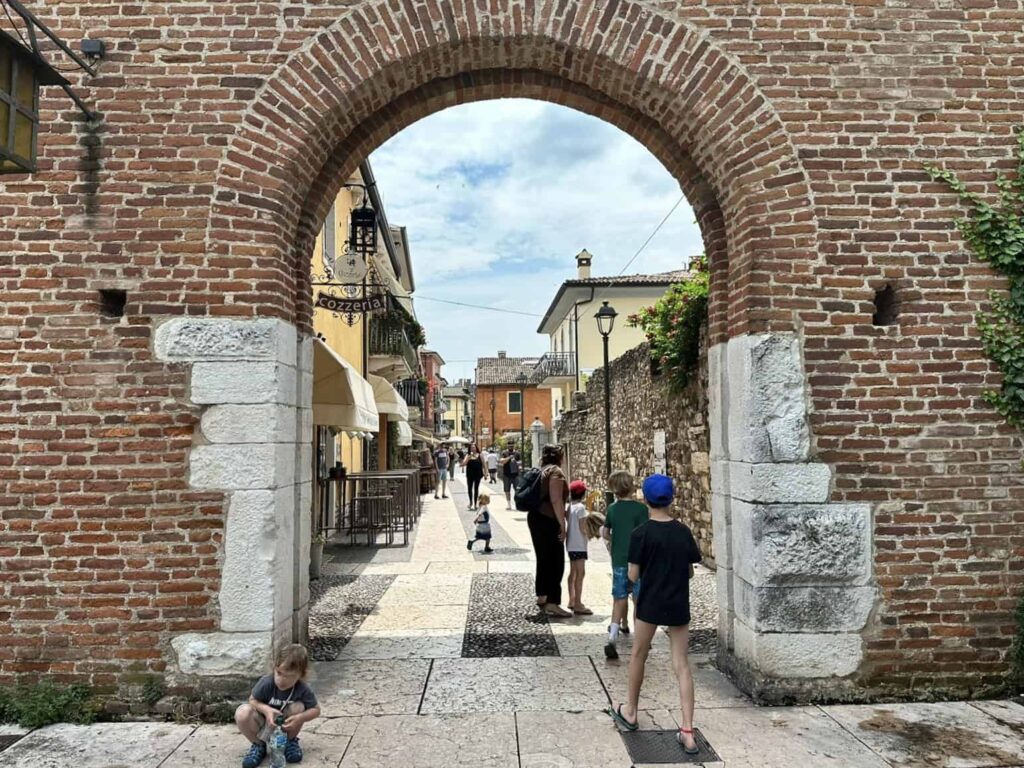 Kids entering archway in Lazise on Lake Garda