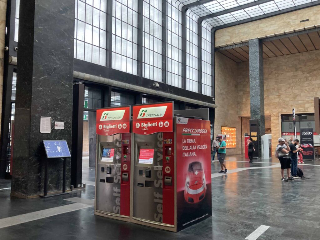 Red ticket machines stand in main hall of the Florence train station.