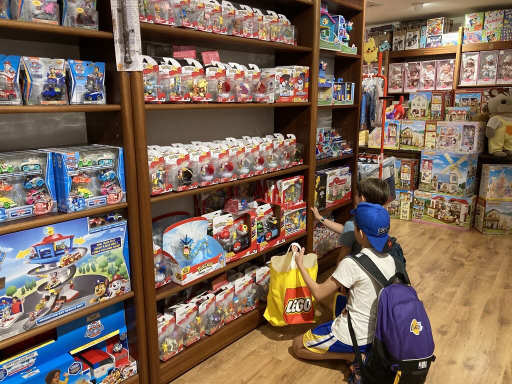 Two boys look at Pokemon toys on a shelf in a toy store in Milan.